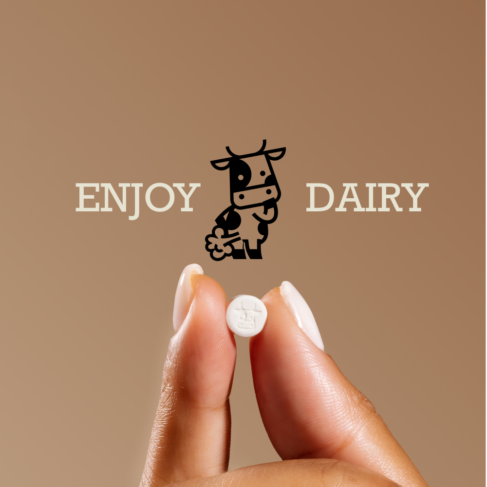 Photo of hand holding pill with text enjoy dairy