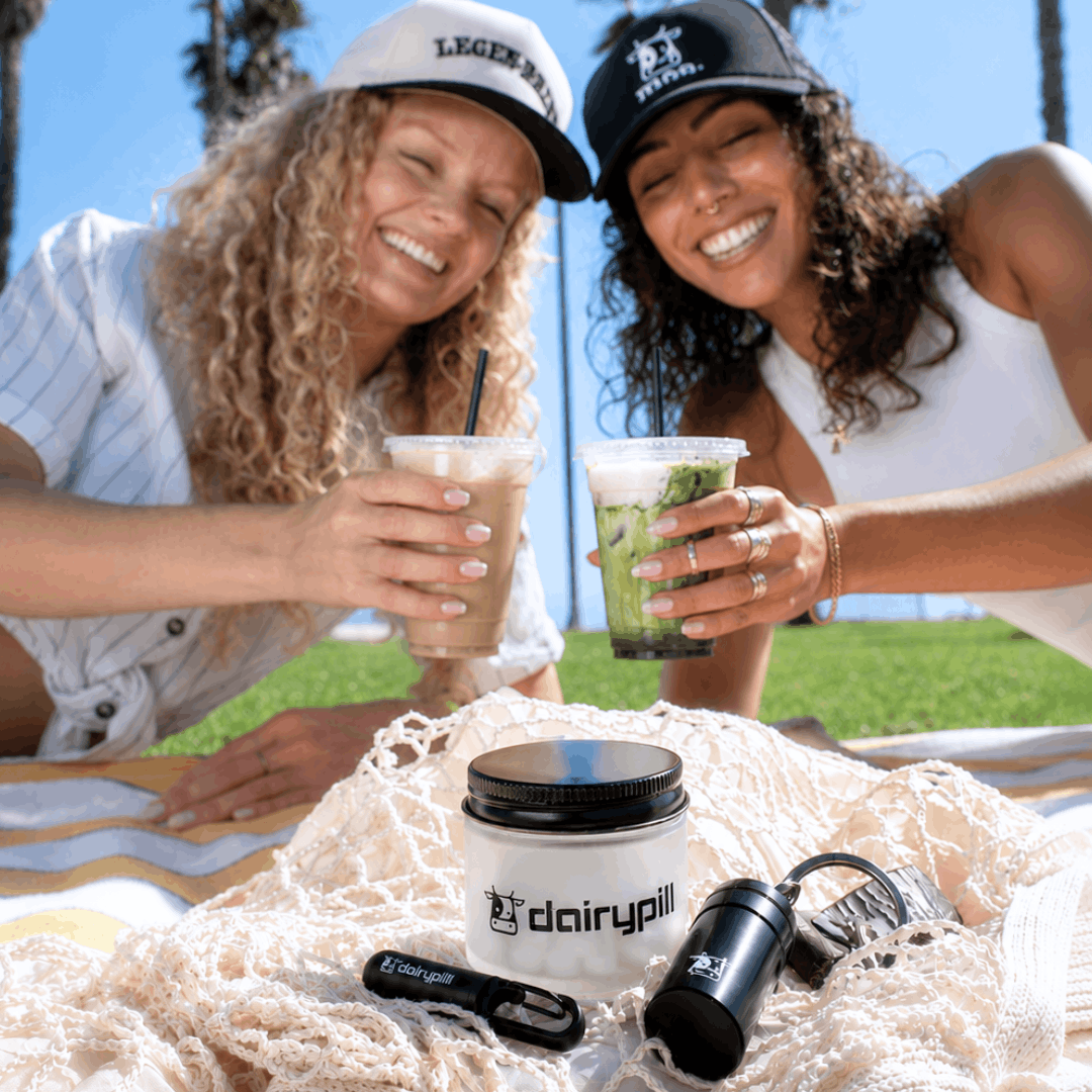 DairyPill lifestyle image. Picnic product photoshoot with models enjoying creamy lattes in the background.