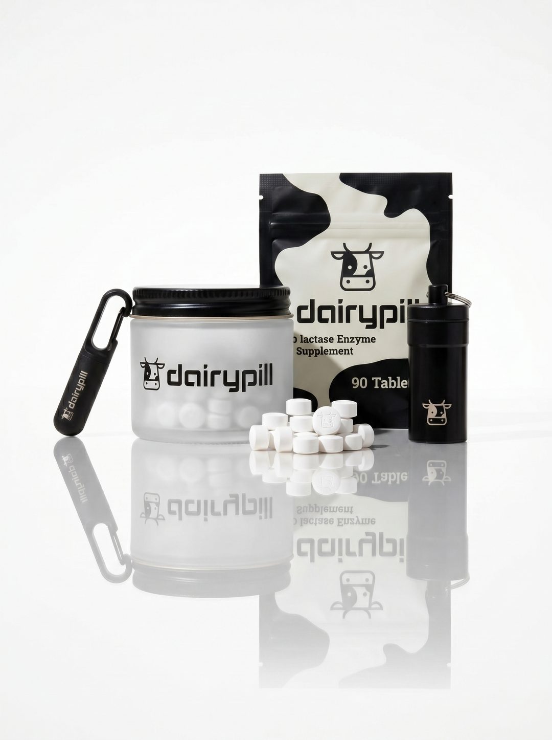 DairyPill Starter Kit: frosted jar, cow-print pouch, Key Pod keychain cases, and tablets